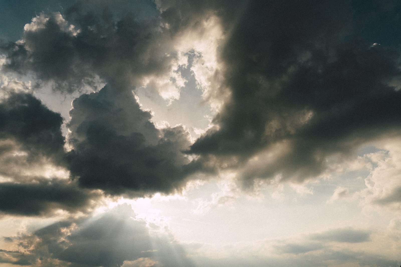 the sun is shining through the clouds over the ocean